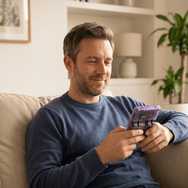 Person playing the Tryzovira Pro 2.0 R36S retro gaming console at home